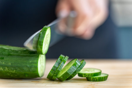 Fresh cucumber slices. Vegetable cutting. Healthy eating