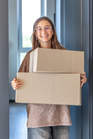 Parcel at doorway. Smiling girl. Online shopping