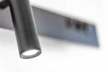 LED wall spotlight. Black cylinder. Minimal glow.の写真素材