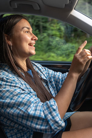 Smiling woman driver on the move. Vertical profile