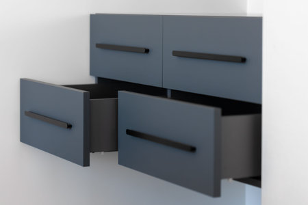 Blue floating cabinet. Open drawers. Minimal interior.の写真素材