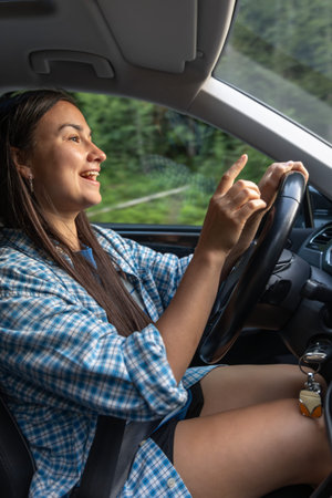 Joy on the road, weekend behind the wheel. Smiling woman driver