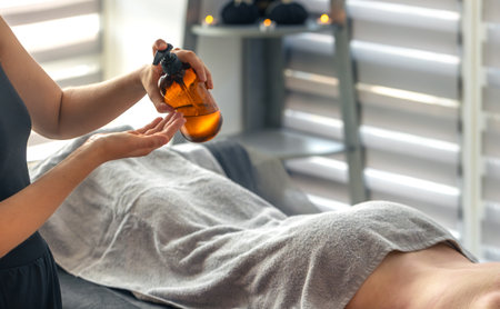 Pouring oil for spa procedure. Care aestheticsの写真素材