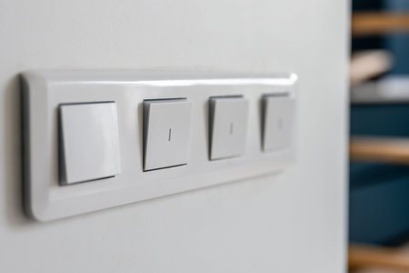 Four light switches in macro with bokeh background. Minimal design.