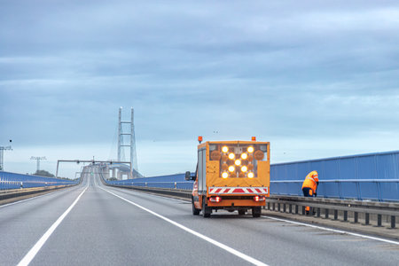 Roadworks on bridge with warning vehicle. Safe maintenance.の写真素材