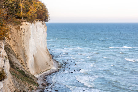 White chalk cliffs above the blue sea in sunlight. Baltic coast from above.の写真素材