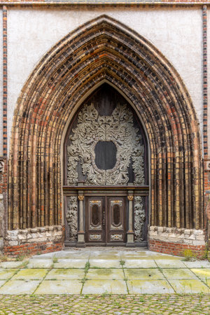 Ornate carved portal of old temple. Gothic decorative door.の写真素材