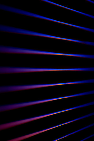 Neon beams with orange accent in darkness. Synthwave neon.