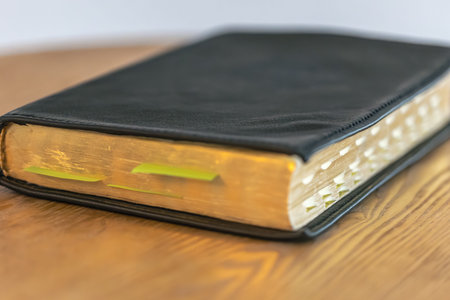 Closeup Bible with golden edges and tabs. Faith details.