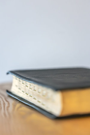 Minimal Bible with clean background. Copyspace calm.