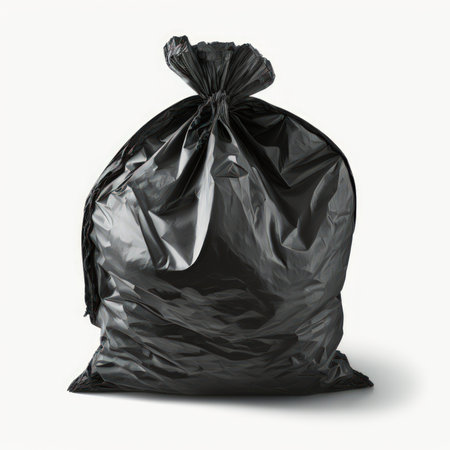 Black garbage bag isolated on white background, clipping path included. Top view.の素材