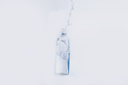 Water splashes out of the bottle