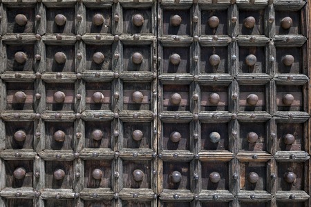 Medieval wooden doors of the Naples Cathedral, the main church of Naples, southern Italy, commissioned by King Charles I of Anjou, completed in the early 14th century under Robert of Anjou.の写真素材
