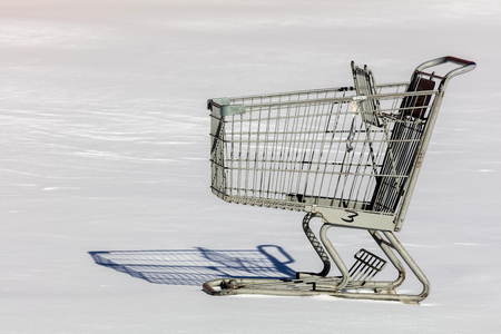Shopping cart on the snow covered parking lot in Brooklyn, NY the next day after the blizzard of 2016の写真素材