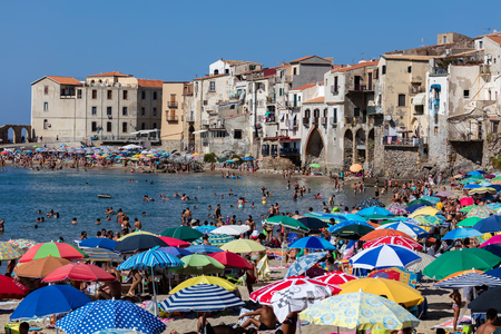 CEFALU, ITALY - AUGUST 21 2016: Cefalu's beach is considered one of the best beaches in Sicily. The beach is a major tourist attraction and is usually crowded during the summer months.のeditorial素材