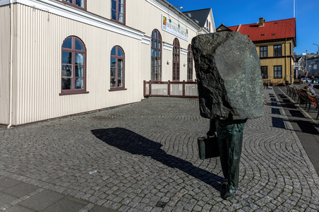 Monument to the Unknown Bureaucrat, a 1994 sculpture by Magnus Tomasson depicts a man in a suit with his head and shoulders subsumed in a slab of unsculpted stoneのeditorial素材