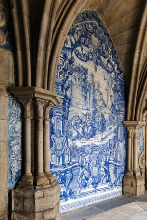 The cloister walls of Porto's Cathedral are decorated with the traditional Portugese blue and white painted tin-glazed ceramic tiles called Azulejos.のeditorial素材