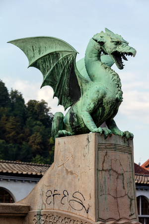 Dragon statue on the Dragon Bridge in Ljubljana, Slovenia. The bridge, decorated with the Dragon statues at four corners, was built in 1901 and since then has become a symbol of the city.の写真素材