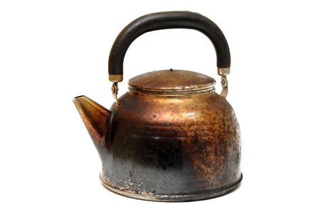 Old sooty kettle on a white background の写真素材
