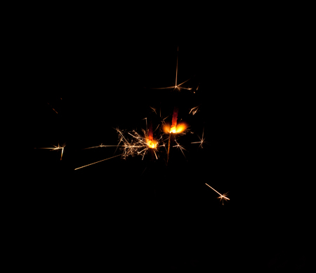 Two sparklers on a black backgroundの写真素材