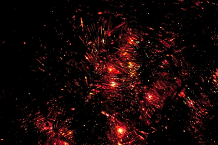 Tinsel and Christmas lights on dark background. Shallow depth of fieldの写真素材