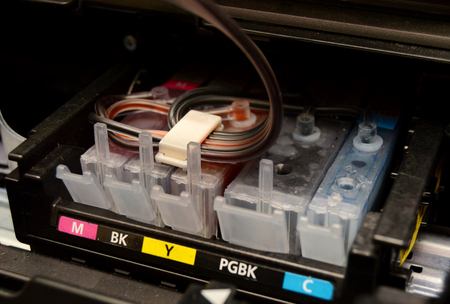 Cartridges an inkjet printer with an installed continuous ink supply system. Close-upの写真素材