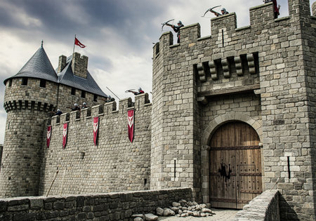 Archers defending the battlements of a stone castle during a siegeの素材
