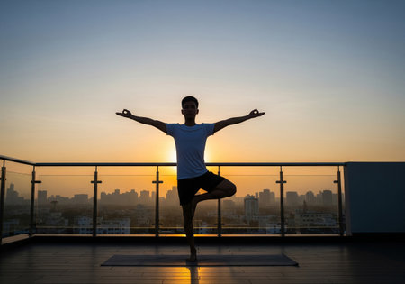 Stylish Man Working on Laptop at a Modern Office Deskの素材