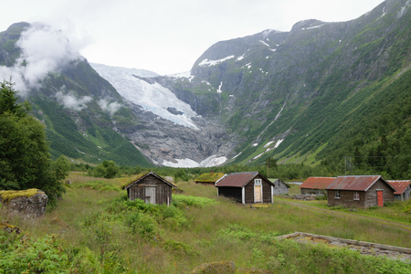 houses in the countryside near the snowy mountainsの写真素材