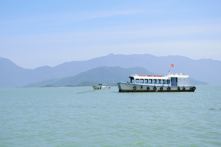 small passenger ship near the tropical coast of Vietnamの写真素材