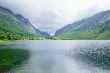 Lake in the mountains between two rocky hillsの写真素材