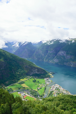Village at the foot of the hill near the shores of the fjordの写真素材