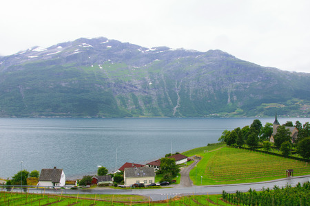 view of the rocky shore of the fjord from the village Loftus Norwayの写真素材