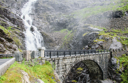 Stone bridge in the mountains. Waterfall near the serpentine. Trollstigenの写真素材