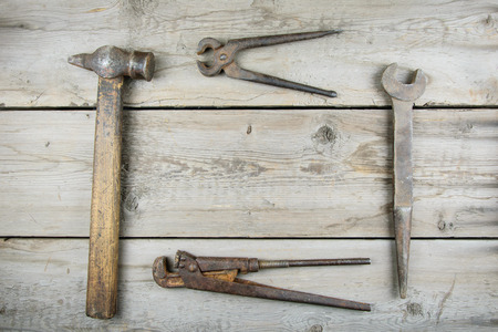 Old wooden desktop. Old rusty carpentry tools. Horizontal mockupの写真素材