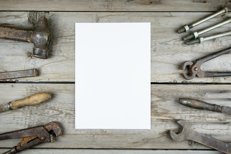 Old wooden desktop. Old rusty carpentry tools. Vertical mockupの写真素材