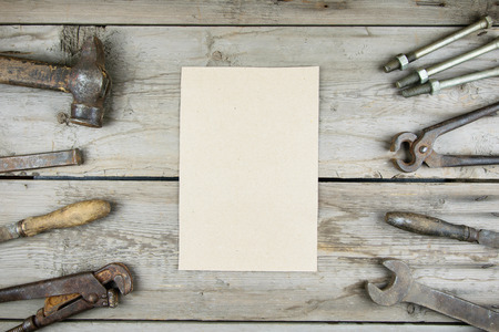 Old wooden desktop. Old rusty carpentry tools. Vertical mockupの写真素材