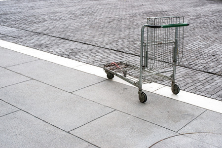 Poor shopping cart in parking lotの写真素材