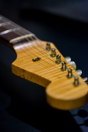 part of the electric guitar called headstock on the dark backgroundの写真素材
