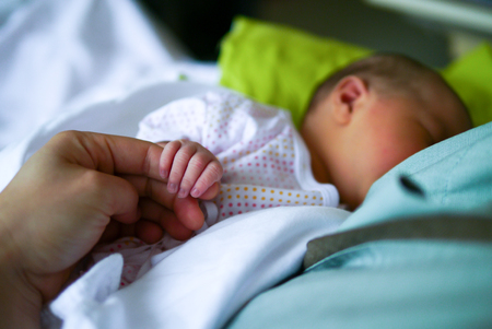 mother and new born baby hands, close upの写真素材