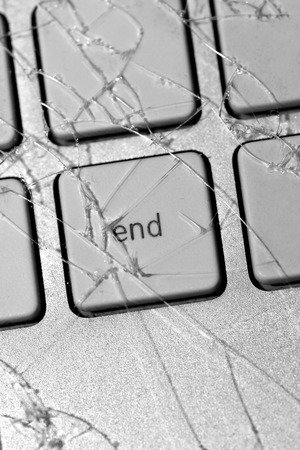 Unhappy ending: cracked glass tempered screen on computer keyboardの写真素材