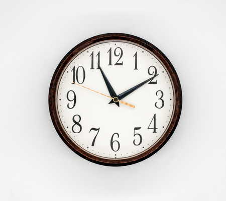 vintage round wall clock white face isolated on white backgroundの写真素材