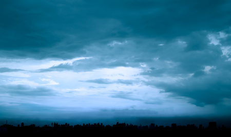 dark blue sky and blurred sky cover all over the cityの写真素材