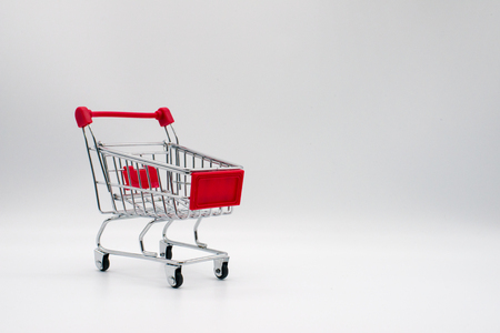 miniature shopping cart isolated on backgroundの写真素材