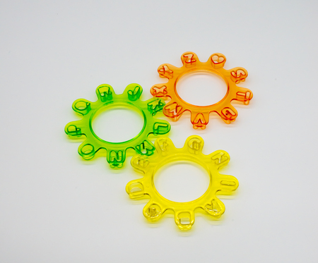 Alphabet cutters setup as mechanical wheels on white isolated backgroundの写真素材