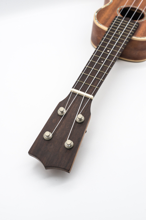 Headstock of the ukulele satin finished isolated on white background.の写真素材