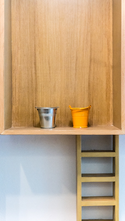 Mini empty buckets in wooden shelf for decorationの写真素材