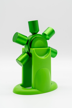 Spinning green fidget aluminum spinner with stand isolated on white background.の写真素材