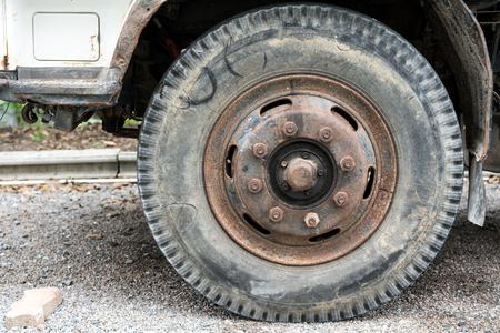 Overused front tire of old truck on stonegroundの写真素材