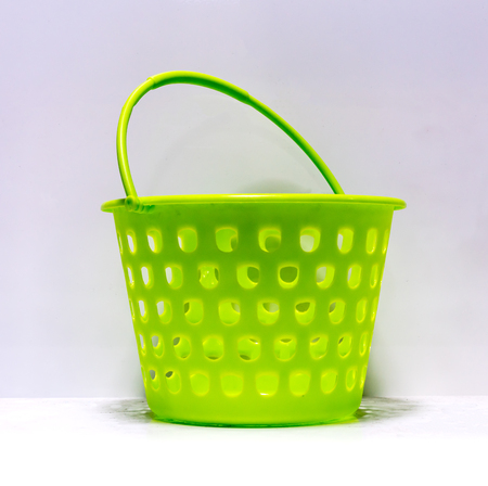 Green round-shaped multipurpose basket isolated on white backgroundの写真素材